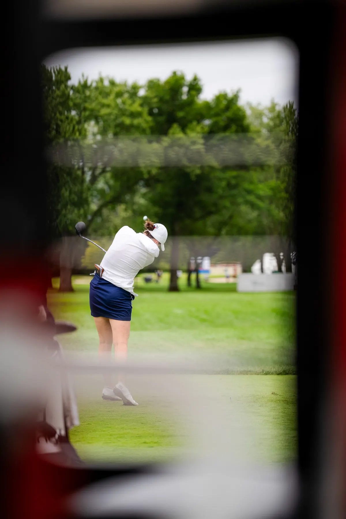 A tee shot seen through a window frame